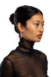 ASYMMETRIC RAW TURTLENECK IN BLACK MESH